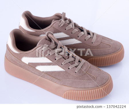 Sneakers on white background top view. Shoes suede light brown beige cut out 137042224