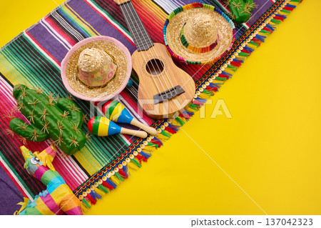 Festive mexican fiesta objects on colorful yellow background 137042323