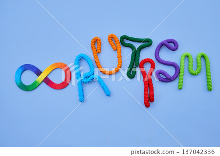 Neurodiversity infinity symbol and autism word on blue background Neurodiversity infinity symbol and autism word on blue background 137042336