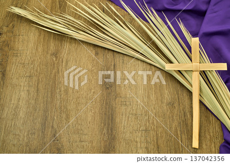 Palm cross, palm fronds, and purple fabric on wood Palm cross, palm fronds, and purple fabric on wood 137042356