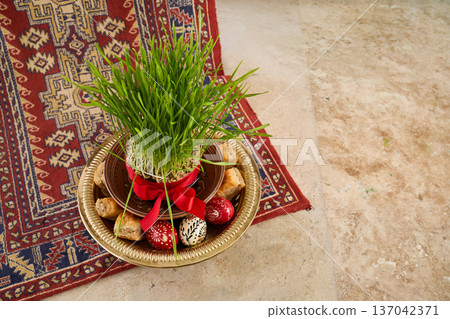 Nowruz celebration displaying sabzi, sweets, and painted eggs Nowruz celebration displaying sabzi, sweets, and painted eggs 137042371