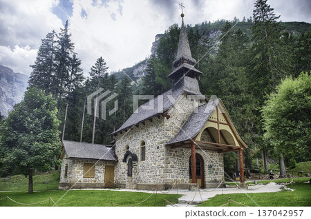 Chapel standing on Lake Braies in the Italian Dolomites Chapel standing on Lake Braies in the Italian Dolomites 137042957
