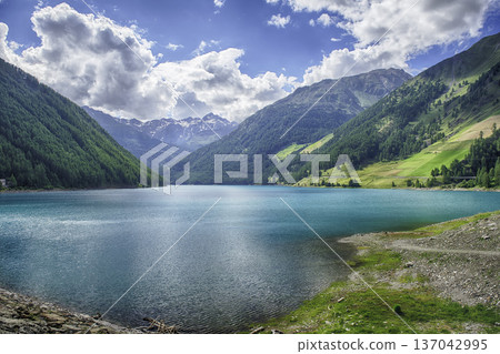 Lake Vernago reflecting the blue sky, Trentino Alto Adige, Italy 137042995