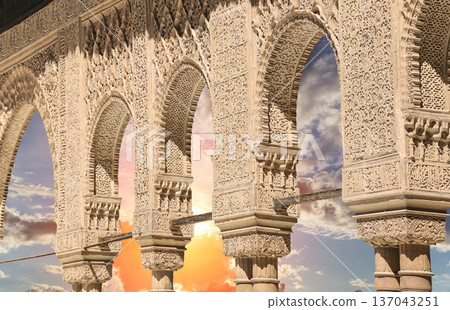Arches in Islamic (Moorish) style (against the sunset) in Alhambra, Granada, Spain Arches in Islamic (Moorish) style (against the sunset) in Alhambra, Granada, Spain 137043251