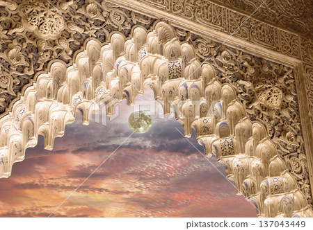 Arches in Islamic (Moorish) style (against the sunset and supermoon) in Alhambra, Granada, Spain Arches in Islamic (Moorish) style (against the sunset and supermoon) in Alhambra, Granada, Spain 137043449