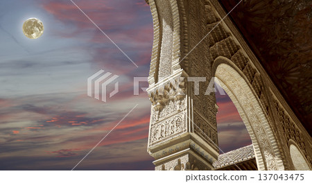 Arches in Islamic (Moorish) style (against the sunset and supermoon) in Alhambra, Granada, Spain Arches in Islamic (Moorish) style (against the sunset and supermoon) in Alhambra, Granada, Spain 137043475
