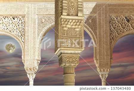 Arches in Islamic (Moorish)  style (against the sunset and supermoon) in Alhambra, Granada, Spain 137043480