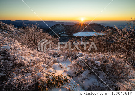 Mount Akagi in winter: Frozen pond and frost sparkling in the morning sun as seen from Jizo-dake Mount Akagi in winter: Frozen pond and frost sparkling in the morning sun as seen from Jizo-dake 137043617