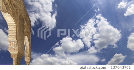 Arches in Islamic (Moorish) style (against the background of a beautiful sky with clouds) in Alhambra, Granada, Spain 137043761