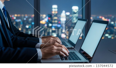 The hands of a business person operating a laptop in the office 137044572