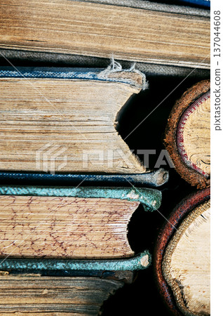 Stack of old books close up. Books in a row or stacked. Vintage or retro books. 137044608