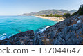 Awesome panoramic view on sea coast and mountains. Tourists beach in Turkey, Alanya. Clear sunny day with rocky beach and seaside and turquoise water 137044647