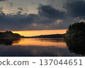 Amazing landscape of lake at colourful sunset with gold clouds as mirror on the surface of water with awasome reflections 137044651