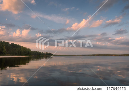Beautiful landscape of lake at colourful sunset with pink clouds mirror in surface of water reflection Beautiful landscape of lake at colourful sunset with pink clouds mirror in surface of water reflection 137044653