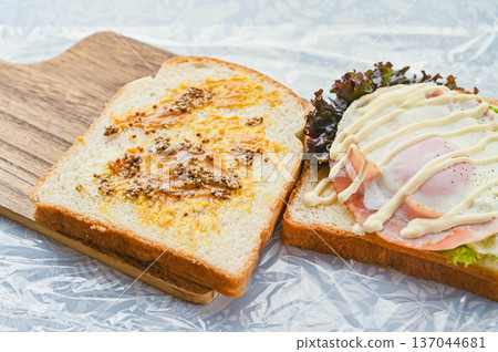 Bacon and eggs sandwiched between slices of bread Bacon and eggs sandwiched between slices of bread 137044681