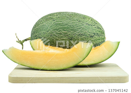 Green melon or cantaloupe sliced on top wooden chopping board 137045142