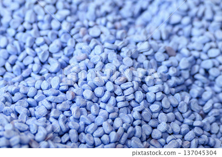 Macro view of high quality blue thermoplastic polymer granules (pellets) for industrial plastic injection molding and extrusion processes. 137045304