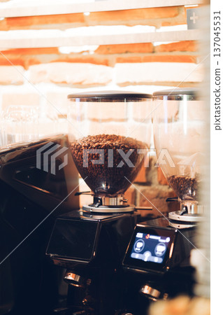 Coffee Grinder with Fresh Beans in Cafe Interior Coffee Grinder with Fresh Beans in Cafe Interior 137045531