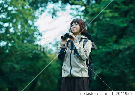 Young woman hiking in green space 137045936