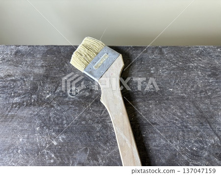 Plasterer's brush, a work tool at a construction site 137047159