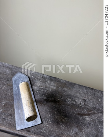 Plastering trowel placed on a workbench with copy space 137047225