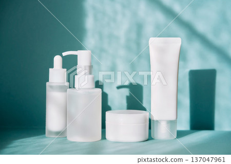 Skincare product packaging mockup on teal background with shadows 137047961