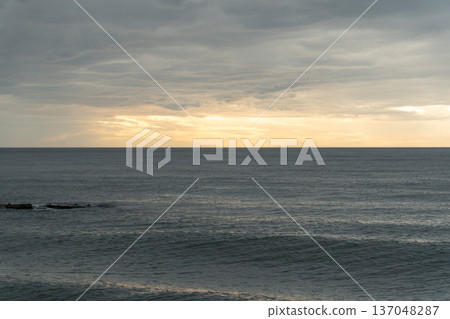 Calm Black Sea horizon under layered cloudy sky with soft golden light near sunset, wide seascape with muted blue gray tones and minimal composition. Tourism promotion, wellness branding, travel Calm Black Sea horizon under layered cloudy sky with soft golden light near sunset, wide seascape with muted blue gray tones and minimal composition. Tourism promotion, wellness branding, travel 137048287