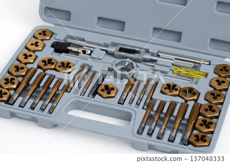 Comprehensive tap and die threading tool set with titanium coating in a gray plastic organizer case. Comprehensive tap and die threading tool set with titanium coating in a gray plastic organizer case. 137048333