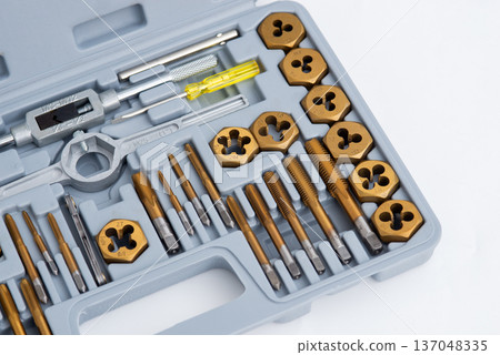 Professional tap and die set with titanium coating for thread cutting in a gray storage case. 137048335
