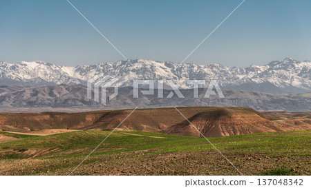 Agafay Desert with High Atlas Mountains in Morocco Agafay Desert with High Atlas Mountains in Morocco 137048342