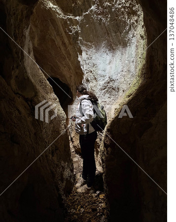 Hiker in a cave  137048486