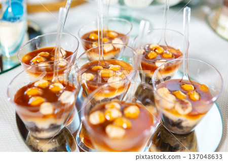 Delicious Layered Dessert Cups With Caramel and Almonds Served at a Festive Event 137048633