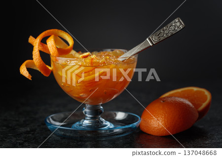 Homemade orange marmalade in a glass bowl garnished with irange pell. 137048668