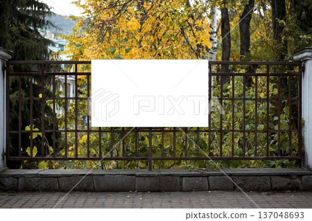Blank white banner for advertisement on the fence of the park in the city 137048693