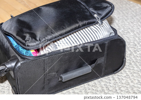 Packed travel suitcase ready for vacation trip. Packed travel suitcase ready for vacation trip. 137048794