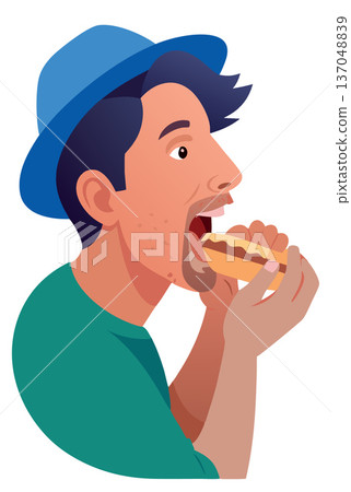 Young man is enjoying eating a hot dog 137048839