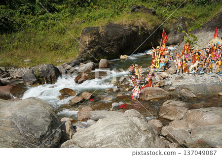 Hindu goddess Durga idols placed in a flowing mountain river for the traditional immersion ritual Hindu goddess Durga idols placed in a flowing mountain river for the traditional immersion ritual 137049087