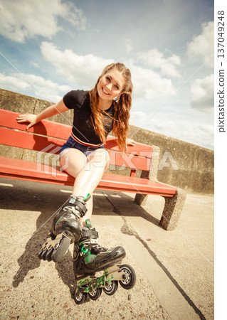Young woman riding roller skates Young woman riding roller skates 137049248