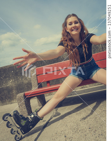 Joyful girl wearing roller skates Joyful girl wearing roller skates 137049251