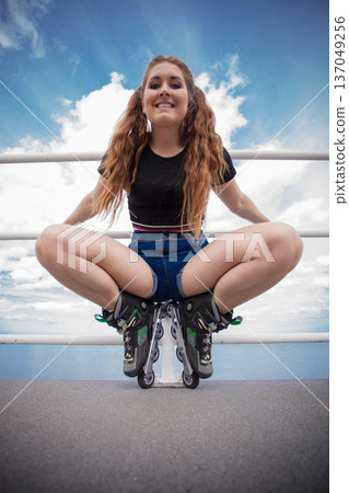 Happy crazy woman wearing roller skates Happy crazy woman wearing roller skates 137049256
