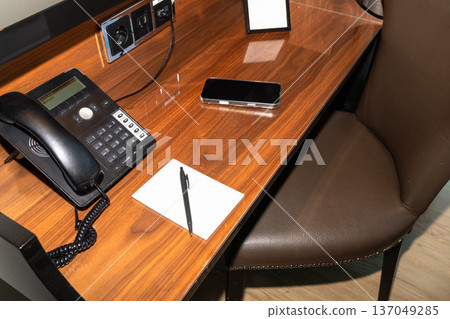 Guest workspace with room service phone on desk. Guest workspace with room service phone on desk. 137049285