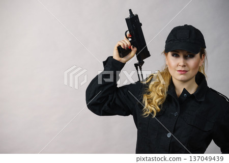 Woman holds gun in hands. Woman holds gun in hands. 137049439