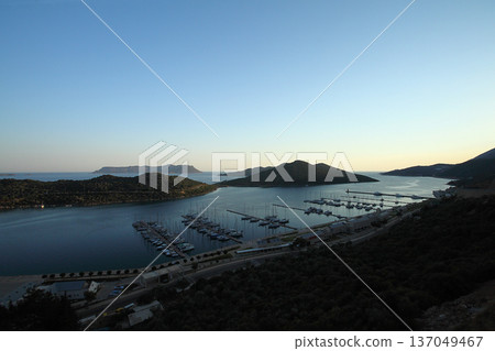View from the bird's eye of the Kas city district of Antalya Province of Turkey Asia. Colorful spring sunset in small Mediterranean yachting and tourist town. View from the bird's eye of the Kas city district of Antalya Province of Turkey Asia. Colorful spring sunset in small Mediterranean yachting and tourist town. 137049467