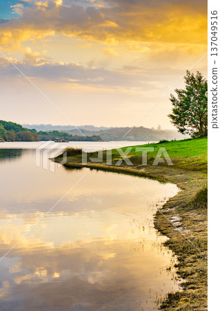 Sunset over autumn lake water 137049516