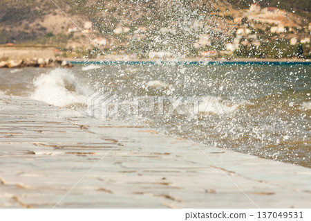 Water splashing on jetty pier Water splashing on jetty pier 137049531