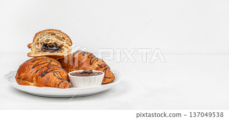 Chocolate filled croissants on white plate with copy space 137049538