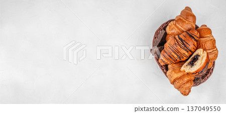 Top view basket of chocolate croissants on light background Top view basket of chocolate croissants on light background 137049550