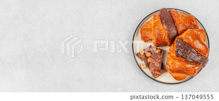Chocolate croissants with hazelnut chocolate on plate, top view with copy space 137049555