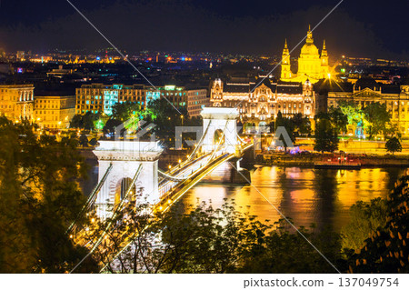 Illuminated Chain Bridge Szechenyi and Saint Istvan Basilica and Danube in night in Budapest Illuminated Chain Bridge Szechenyi and Saint Istvan Basilica and Danube in night in Budapest 137049754