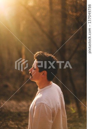 Mindful Man with Closed Eyes Standing in Forest Mindful Man with Closed Eyes Standing in Forest 137049786